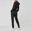 Chic women fleece tracksuit with a zip-up jacket and coordinating pants, perfect for a modern, sporty look.