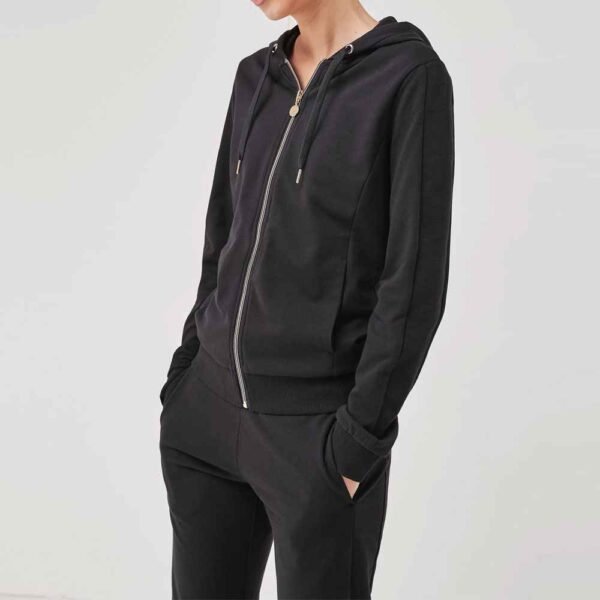 Close-up of a women’s zip-up fleece tracksuit set with stylish pants, offering a comfortable and chic look.