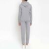 Women fleece tracksuit with zip-up jacket and coordinating pants, showcasing a stylish and functional design.