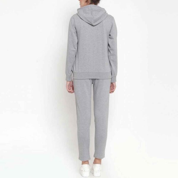 Women fleece tracksuit with zip-up jacket and coordinating pants, showcasing a stylish and functional design.