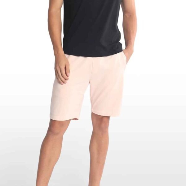 Men’s cotton sweatshorts in a relaxed fit, shown on model wearing casual sneakers.
