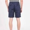 Model turned slightly to show side and back profile of custom-fit French Terry shorts in natural cotton.