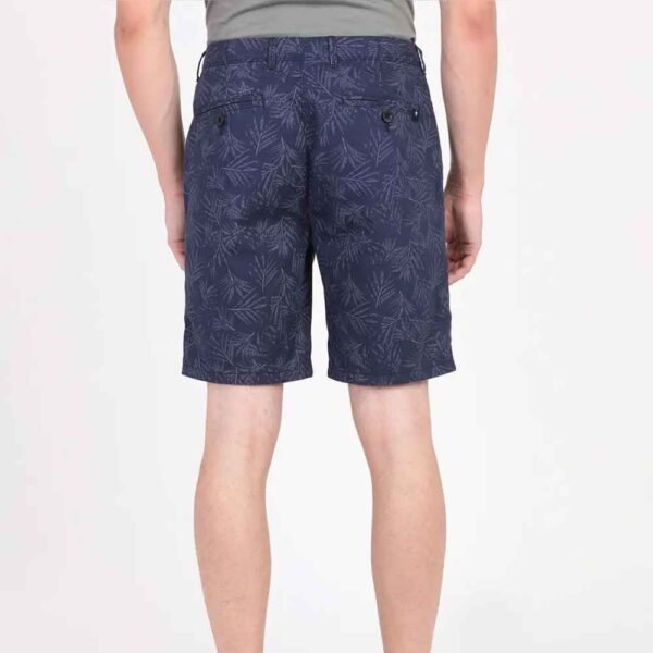 Model turned slightly to show side and back profile of custom-fit French Terry shorts in natural cotton.