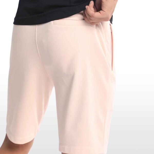 Side angle view of men’s cotton sweatshorts, showcasing pocket placement and relaxed fit.