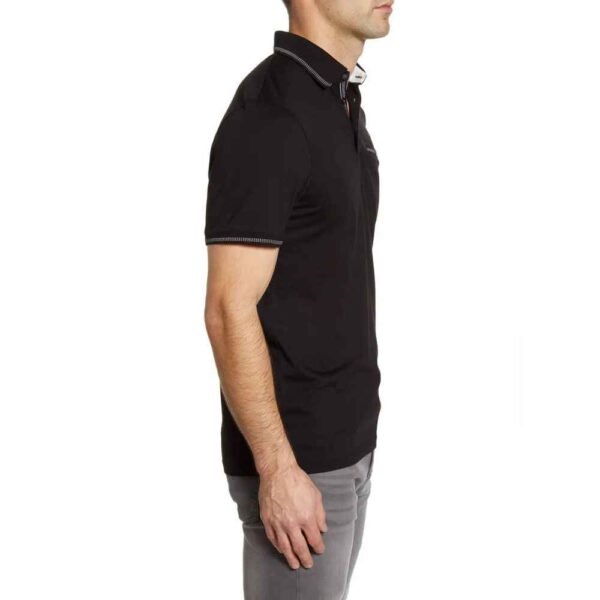 Macro image showing the weave pattern of soft pique cotton fabric in a men’s polo.