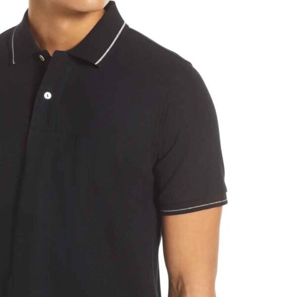 Zoomed-in view of soft breathable cotton pique material used in a men’s casual polo.